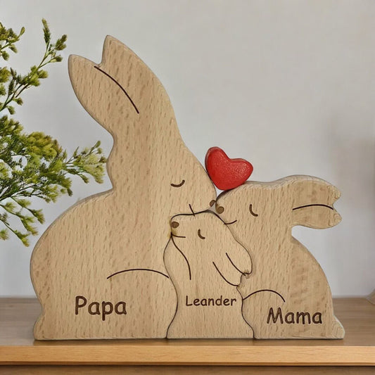 Handmade bunny family puzzle for three people with custom engraving on a wooden surface.