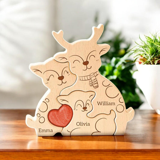 Wooden deer-shaped decoration with engraved names on a wooden surface.