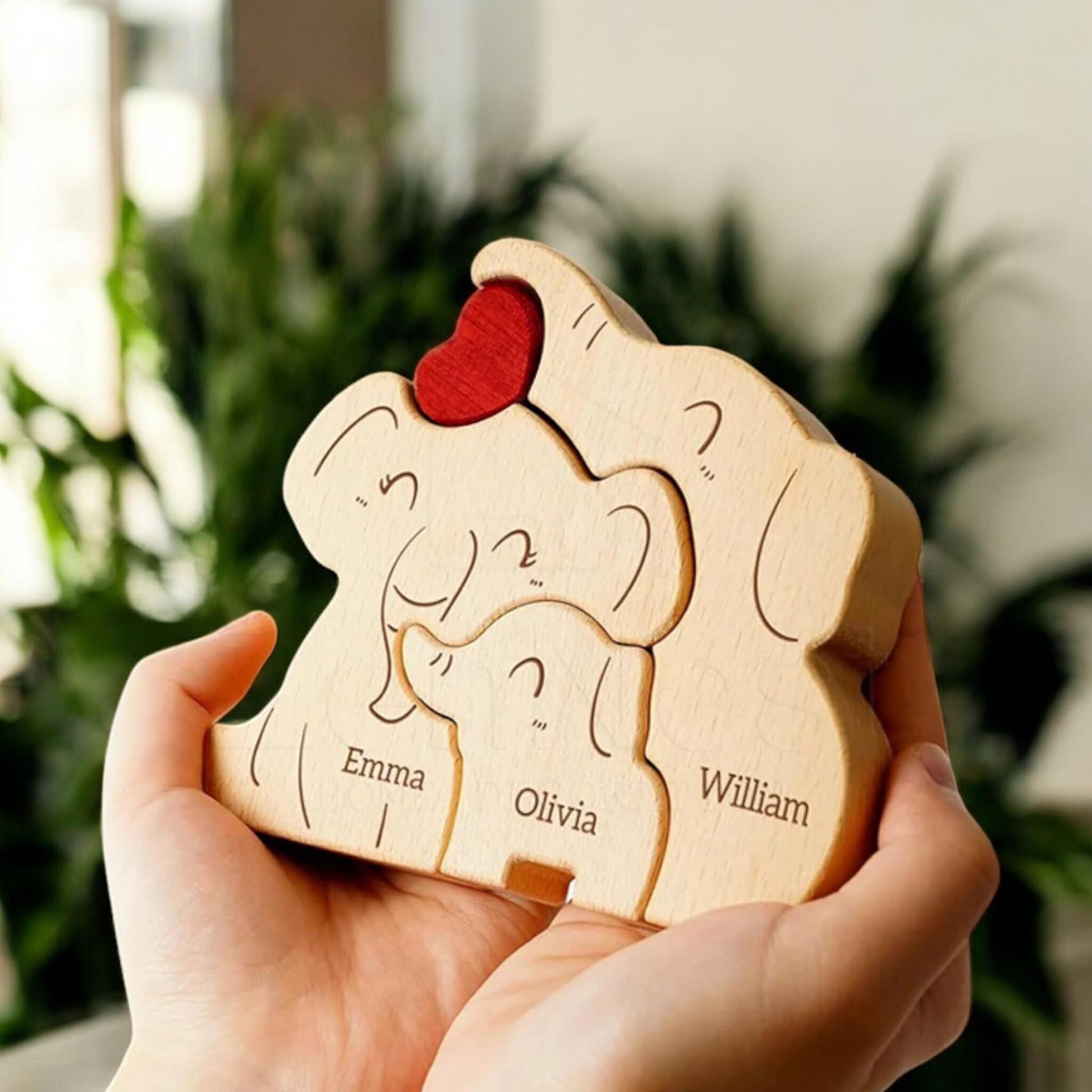 Close up of custom engraved names on wooden elephant family figurines