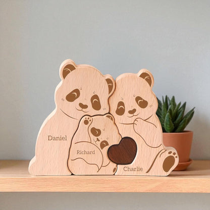 Wooden family of panda bears with engraved names on a shelf.