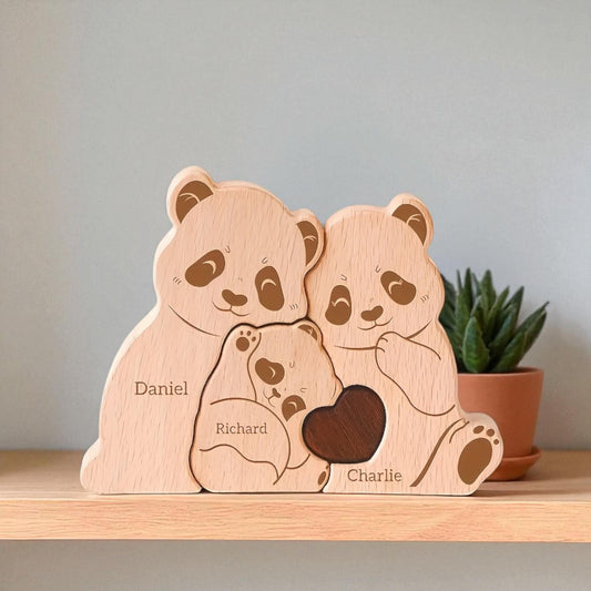 Wooden family of panda bears with engraved names on a shelf.