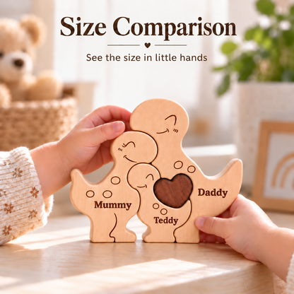 A wooden puzzle toy shaped like a family of four, held by two hands over a table. The puzzle has three light wood pieces labeled 'Mummy', 'Teddy', and 'Daddy' and one darker brown piece in the center with a heart cutout.