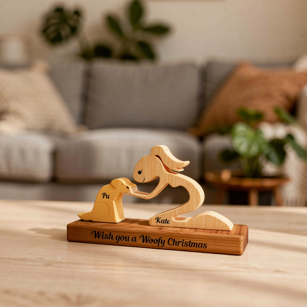 Wooden sculpture of a woman and a dog on a stand with 'Wish you a Woofy Christmas' text, next to a plant.