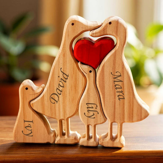 Wooden duck family puzzle four piece set in premium pine wood holding a red heart with engraved names on a wooden surface.