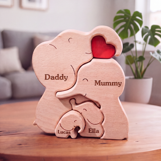 Personalized wooden elephant puzzle toy with engraved names 'Daddy', 'Mummy', 'Lucas', and 'Ella' on a wooden table in a living room setting. Personalised elephant family wooden puzzle for 4 people with custom engraved names