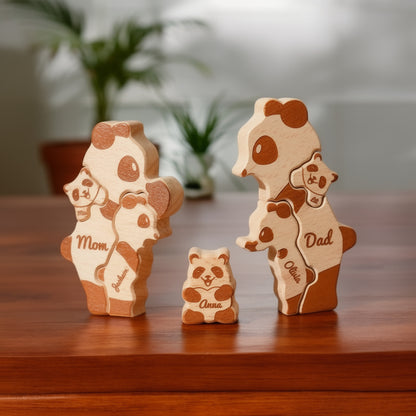 Custom panda family ornament seven member family with personalised engraved names on a shelf with flowers in the background.