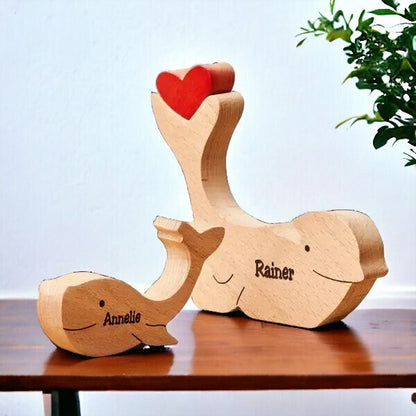 Personalised delphine family wooden puzzle for two people with custom names on a table with a light blue background.