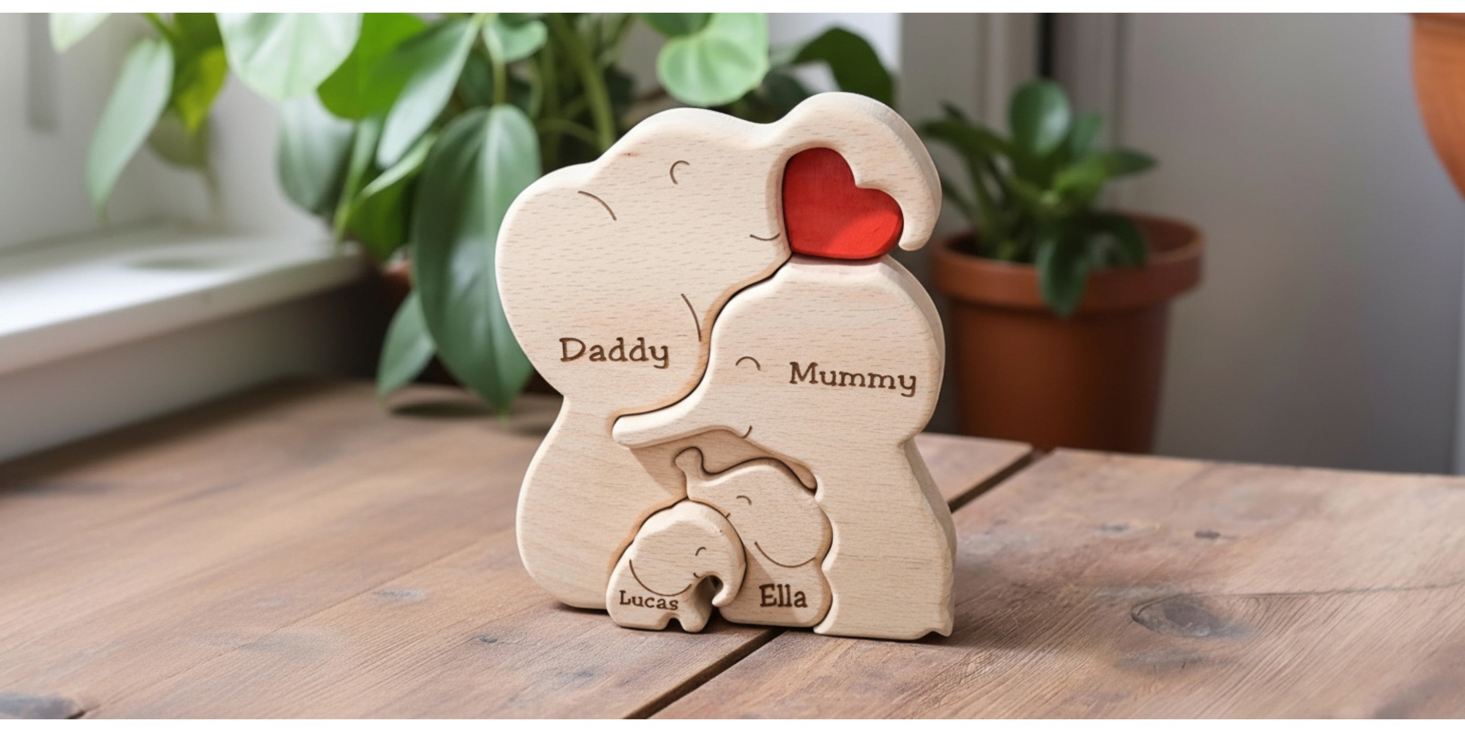 Wood Elephant Puzzle with engraved custom names of the family members, on a premium wood table with a few green plants in the background.