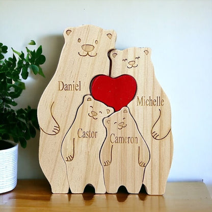 Wooden bear family puzzle with a red heart and engraved names on a wooden surface.
