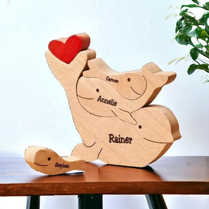 Wooden delphine family puzzle four member family in premium pine wood names on a table.