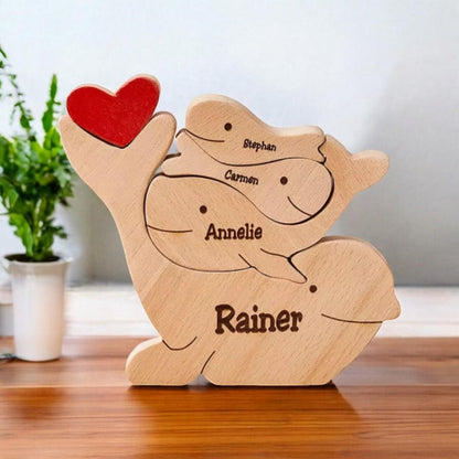 Wooden delphine family puzzle four member family in premium pine wood
with a red heart on a wooden surface.