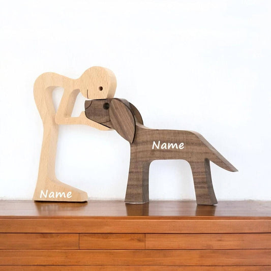 Wooden dog and man figurines on a wooden surface with personalised names