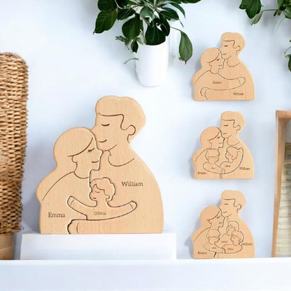 Wooden family figures with engraved names on a white surface with plants in the background