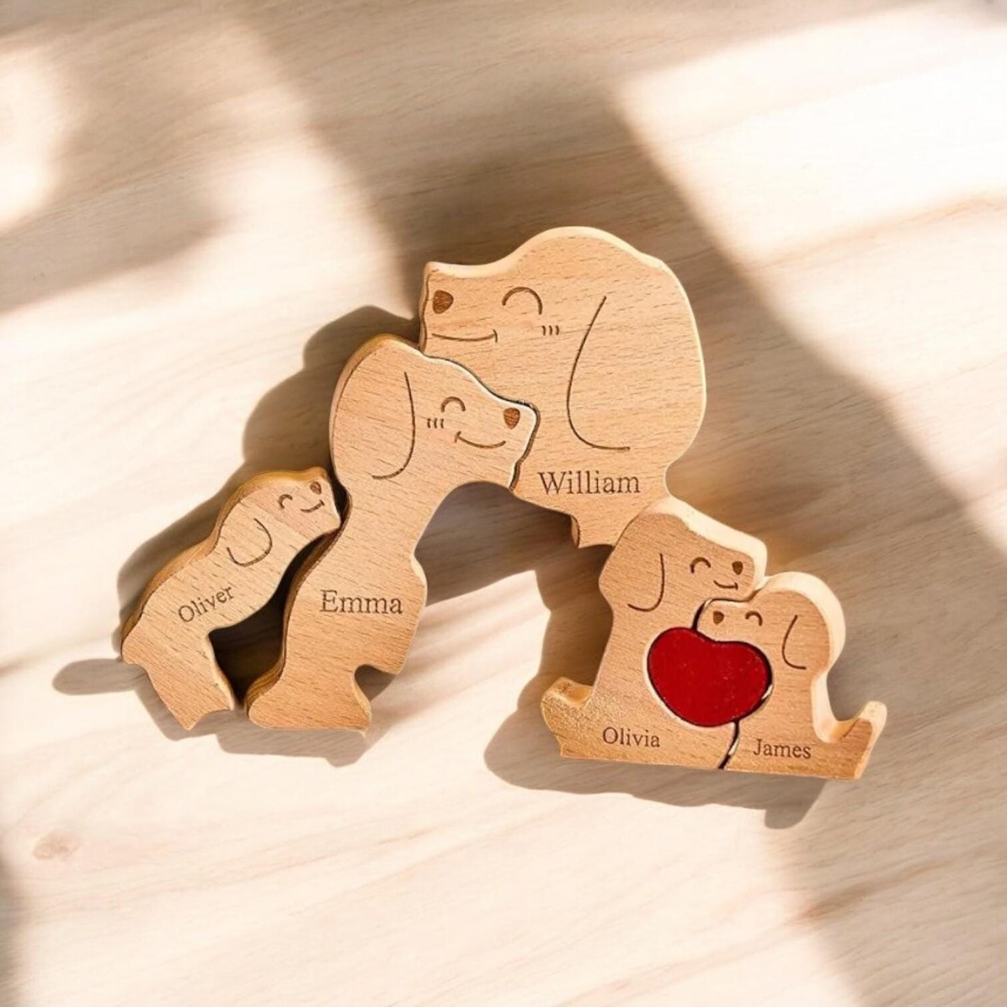 Wooden family figurines with engraved names on a light wooden surface