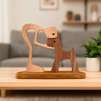 Wooden sculpture of a dog on a stand with a plant in the background