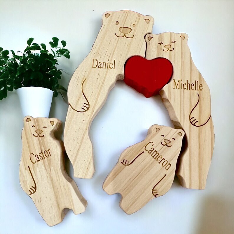 Wooden bear-shaped family portrait with engraved names and a red heart on a white background.