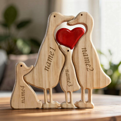 Wooden duck family puzzle four piece set in premium pine wood on a wooden surface.