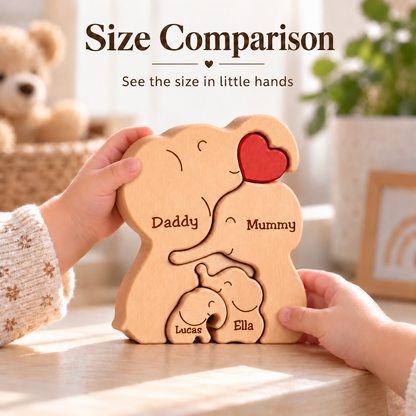 A wooden elephant puzzle toy held by two children's hands on a tabletop, with the words 'Size Comparison' above. The puzzle shows a large wooden elephant split into pieces labeled 'Daddy' and 'Mummy' on the big version, plus smaller matching pieces labeled 'Lucas' and 'Ella'.