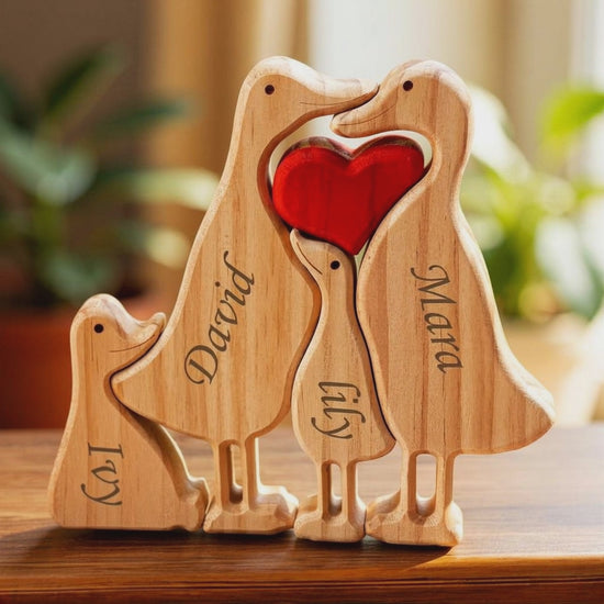 Wooden duck family puzzle four piece set in premium pine wood holding a red heart with engraved names on a wooden surface.